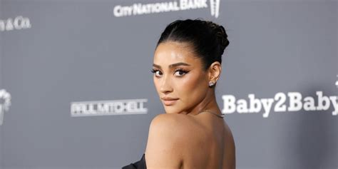 Shay Mitchell just went completely nude, hiding behind a